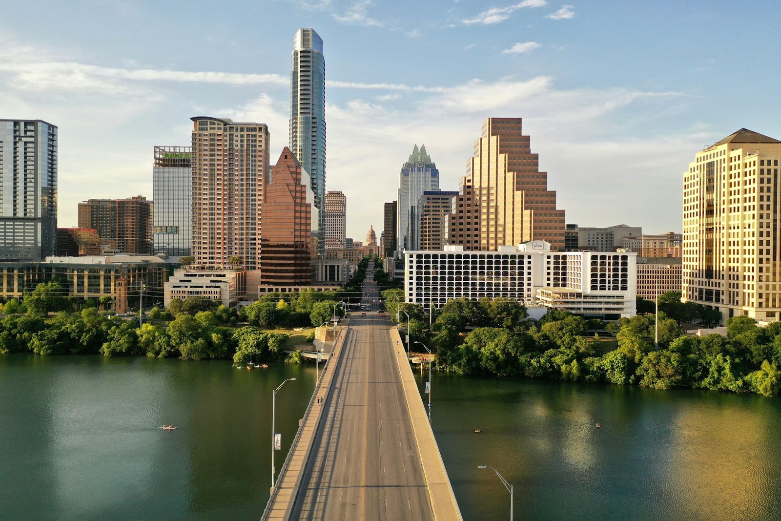 Bridge over Lady Bird Lake leading to the Austin skyline