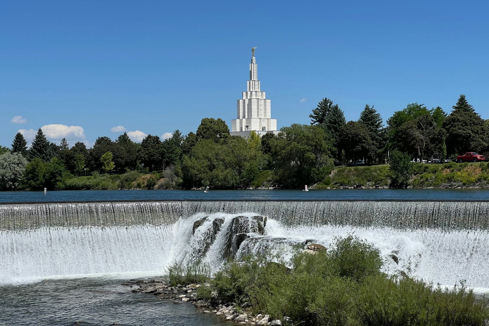 The falls of the Snake River at the River Walk in Idaho Falls, with the Latter-day Saint temple behind